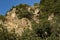 Panorama  with high vertical limestone rocks and niches, ruins of former rock monastery