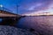 Panorama of high voltage power lines near water at sunset