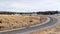 Panorama Highway running through grassy terrain blanketed with snow during winter season