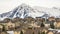 Panorama Hill homes with rugged snow covered mountain peak in the background