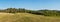 Panorama of a hilly forested landscape near the town of Tisnov in the Czech Republic. A sunny morning in the pasture.