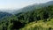 Panorama of hilly green landscapes with a haze in the distance