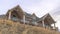 Panorama Home with dormer and two gable roofs over balcony with cloudy sky background