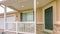 Panorama Home facade with yard and stairs in front of the small porch with furniture