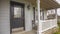 Panorama Home with furniture on the small porch in front of window with wooden shutters