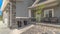 Panorama Home with gray and brick wall and landscaped yard leading to the entrance