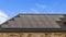 Panorama House with solar panels on the roof against blue sky with clouds