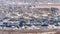 Panorama Houses in Alpine Utah neighborhood amid snowy hill and abundant trees in winter