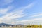 Panorama of a huge blue sky with clouds, a modern seaside town w