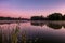 Panorama on huge lake or river in morning with beautiful awesome pink sunrise