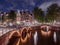 Panorama of the illuminated bridges on the channels at night. Cityscape of Amsterdam, the Netherlands