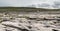 Panorama image of Burren landscape, county Clare, Ireland, Rough stone terrain, Cloudy sky