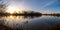 Panorama image of a sunrise on a bend in a river on a calm winter morning