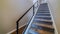 Panorama Indoor stairs of home with metal handrail and gray carpet on the treads