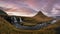 Panorama of Kirkjufellsfoss waterfall and Kirkjufell Mountain in West Iceland