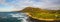 Panorama of Koko Head crater taken from a drone in Hawaii with both a rocky and a sandy beach with the incoming surf