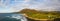 Panorama of Koko Head crater taken from a drone in Hawaii with both a rocky and a sandy beach with the incoming surf