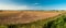 Panorama of the KopaÅ„ lake in the coastal belt. Plowed fields in the foreground. A beautiful, sunny summer afternoon