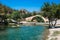 Panorama of kourtaliotis river and a stone arch bridge at Preveli, Crete