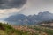 Panorama of Lake Garda, lakeside village Torbole and mountains with dark storm clouds, Italy