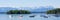 Panorama of Lake Starnberg with Roseninsel rose island and anchoring sailboats