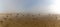 Panorama landscape of fog lifting over an endless wadden sea beach at low tide