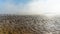 Panorama landscape of fog lifting over an endless wadden sea beach at low tide