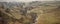 Panorama landscape stream running through valley in Autumn