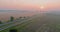 Panorama landscape view in sunrise over the meadow across high speed highway in the morning fog in the thick fog natural