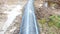 Panorama of large-diameter plastic pipe in forest clearing