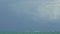 Panorama on large gray clouds on dark stormy sky above endless blue ocean