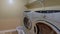 Panorama Laundry room interior with laundry appliances on top od a wooden base podium