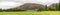 Panorama of the lawn in front of a glasshouse with plants in Benmore Botanic Garden, Scotland