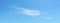 Panorama of light translucent cirrus cloud high in a clear blue summer sky. Meteorology, weather, cloud formation and atmospheric