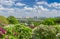 Panorama of lilac plantation against of church, river and city