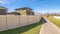 Panorama Long pedestrian walkway between walled houses during day