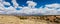 A panorama looking over the desert of northern Arizona with the Vermillion cliffs in the distance