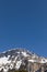 Panorama with lots of snow on Lukmanier in Ticino, on the Swiss Alps. Beautiful closeup of the mountain and blue sky