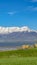 Panorama Lush field with bench overlooking a lake with glistening water on a sunny day