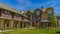 Panorama Lush lawn in the middle of townhomes under blue sky on a sunny day