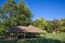 Panorama of the main clearing of Devojacki bunar with its iconic Wooden well in summer. Devojacki Bunar is a touristic settlement