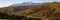 panorama of the Majella mountain with the snow-capped peak and the cultivated land. Beginning of autumn in Italy. Banner