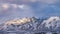 Panorama Majestic mountain covered with snow under blue sky with gray puffy clouds