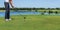 Panorama male golfer hit the ball with stick.