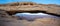 Panorama of Mesa Arch and the canyon below it
