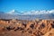 Panorama of Moon Valley in Atacama desert, snowy Andes mountain range in the background Chile