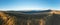Panorama from morning grassy mountain ridge