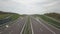 Panorama of the motorway with a bird`s eye view. Transport artery of the country. The movement of vehicles on the highway. Landsca