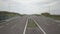 Panorama of the motorway with a bird`s eye view. Transport artery of the country. The movement of vehicles on the highway. Landsca
