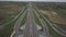 Panorama of the motorway with a bird`s eye view. Transport artery of the country. The movement of vehicles on the highway. Landsca